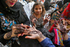 Live henna artist applying intricate natural henna designs at a market event in Sheffield