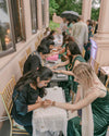Live henna artist creating intricate designs at a community market event in Sheffield.